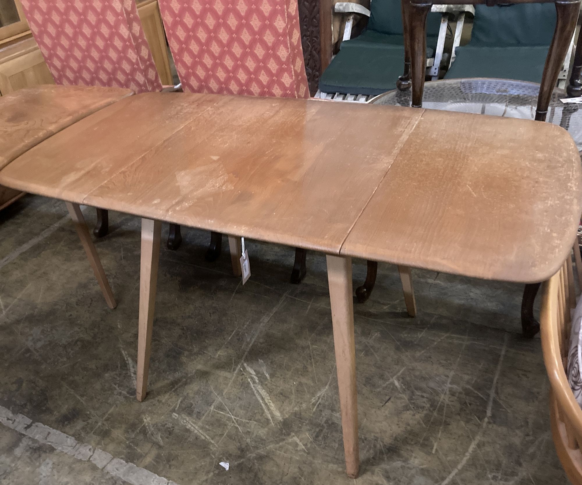 An Ercol elm drop-flap dining table, extended 130cm depth 74cm height 70cm
